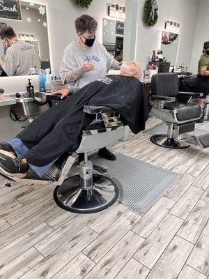 Pops getting his beard and hair trimmed with clippers and straight razor.