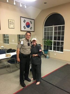 Officer, Father and Returned Black-Belt celebrating daughter passing next belt test.