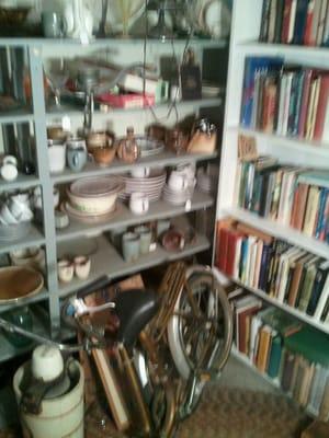 Antiques are mixed in with the books. Check out the cool bike on the floor.