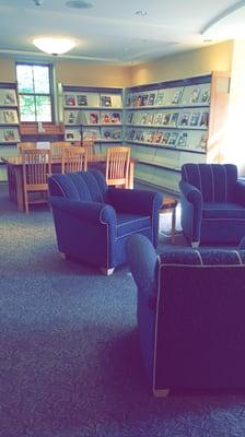 Cozy reading chairs near the fireplace.