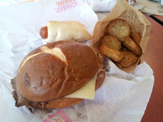 Roast beef pretzel bun with seasoned hashbrowns. And a Dunkin dog, yum!