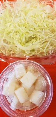 Shredded salad with dressing plus pickled radish.