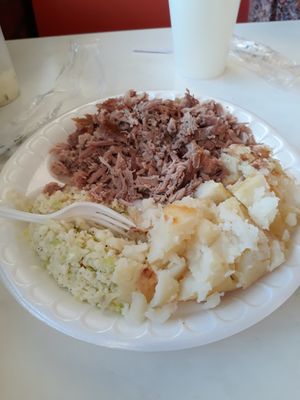 Barbeque,slaw,baked potatoe,and hush puppies.