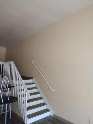 Living room and stairway to dining room in a loft.