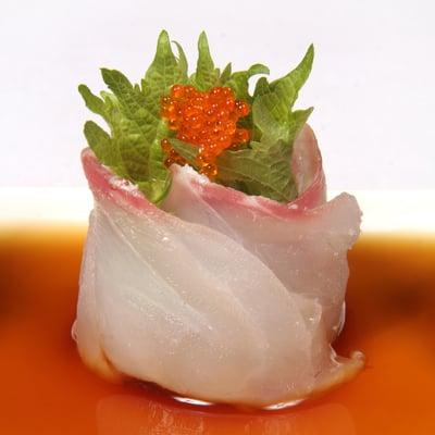 Kampachi sashimi with shiso leaf, tobiko and ponzu sauce.