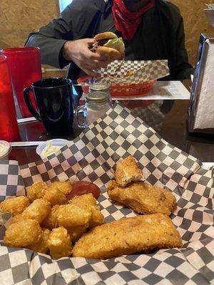 Fish and chips and burger in the background