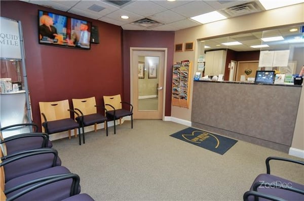 Now Dental of Suffolk patient waiting room with plenty of seats and a TV.