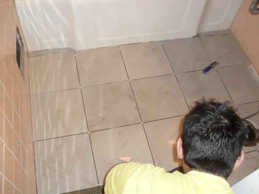 bathroom floor tile installation in progress