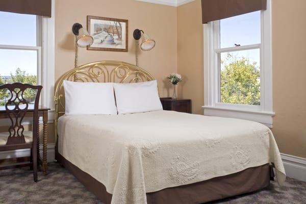 Rodey room on second floor is a small room with brass queen bed, private bath with shower. Great sunset view.