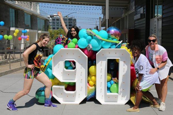 Our Sol Collective team having a blast at Park 12's 90s themed Open House!