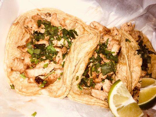 Grilled chicken tacos with fresh cilantro and lime.