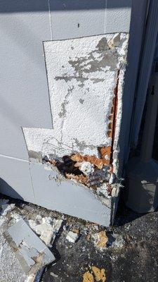 Vechile damage to EIFS stucco in Northville Michigan. The demo step. Stucco building maintenance and repair.