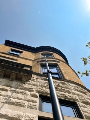 Water fed pole on a brownstone