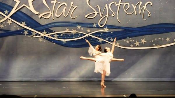 A lyrical duo performing at competition. Lyrical style of dance.