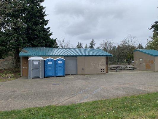 Restroom building with tables to the right.