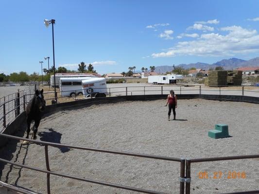 Round pen with free horse trailer parking in background