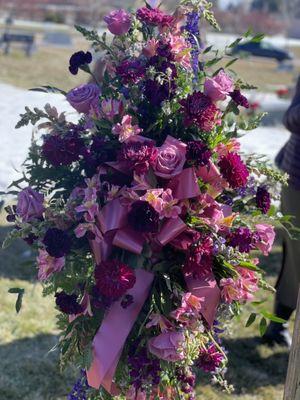 Funeral Spray on stand with pink and purple flowers