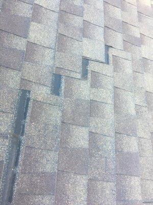 Another section of asphalt shingles beginning to slid off the roof.