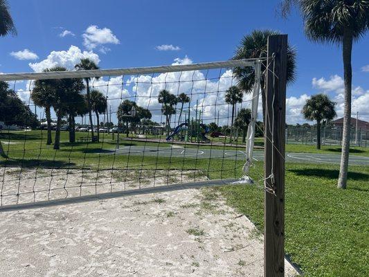 sand volleyball court. basketball court and playground as well as tennis court in front of it