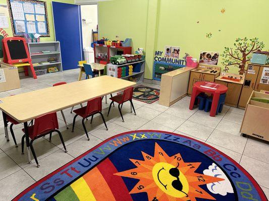 Toddler Room block center, dramatic play area, art area, literacy center, circle time carpet