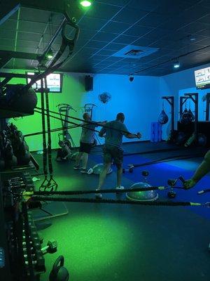 Action shot of our gym.   Members using power bands during one of our HIIT circuits.