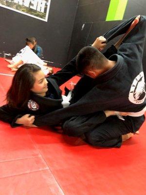 Kids class working on sweeps and spider guard.