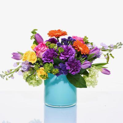 Bright blooms designed in colorful vase. Local delivery to Sylvania and the Toledo area.