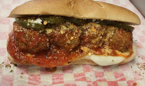 Italian Meatball Sandwich, Marinara, Melted provolone & Parmesan served spicy on request.