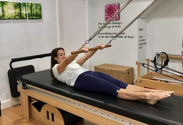 Jenny Demarziani demonstrating "Assisted Rollups" on the Trapeze Table.