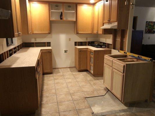 Replaced one curved cabinet to open up kitchen, 20 year old oak cabinets prior to Anthony repainting