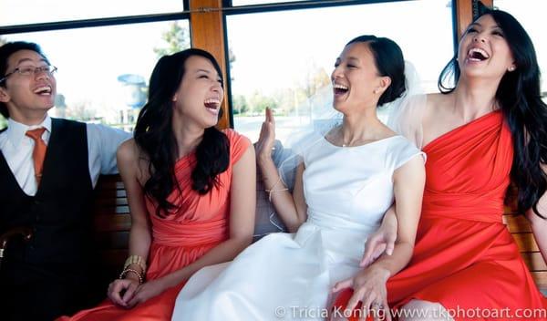 bride laughing hysterically with siblings