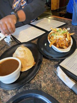 Pasty with gravy and poutine.