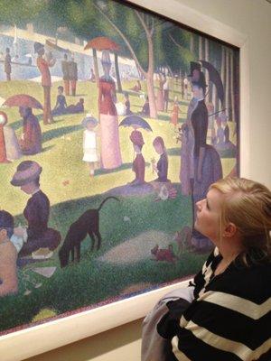 Art appraiser and art consultant Nora Desruisseaux examining a George Seurat painting at the Art Institute of Chicago.