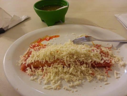 Enchilada Mexicana. Tortilla cooked in a red sauce with queso fresco inside and crumbled on to as well.