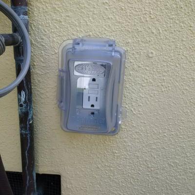 added a proper outlet cover for an outside location where something is kept plugged in.