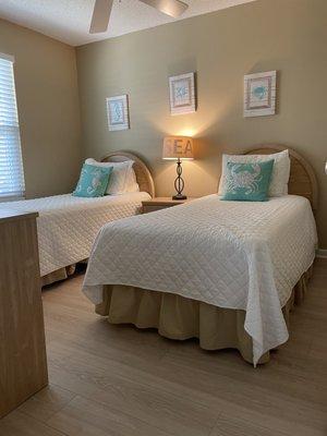 Guest bedroom with twin beds and new floors.