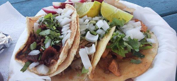 Refried Bean Crispy Thick Bacon, Flavorful Carnitas & Tender Chicarron Tacos. Fresh made Corn Tortillas perfectly heated on grill.