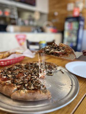 Pepperoni and mushroom and sausage pizza