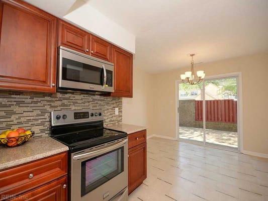 Cherry Cabinets and Desert Gold Granite by Global Home Decor.