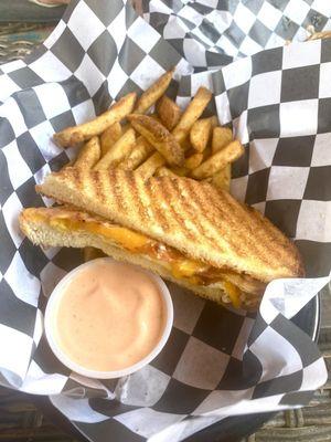 Bacon, cheddar and egg panini with Cajun fries and their signature sauce