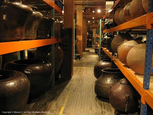 One of numerous rows of large urns and pots.