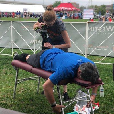 Dr. Amy working on an athlete post-race at the Rock-N'-Roll Race last March.