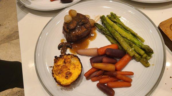 Filet mignon with mushroom & pearl onion demi with sautéed garlic asparagus and a cheddar cheese cauliflower muffin