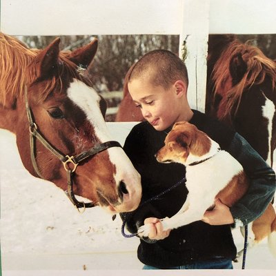 Old portrait at a barn with son, horses and pups