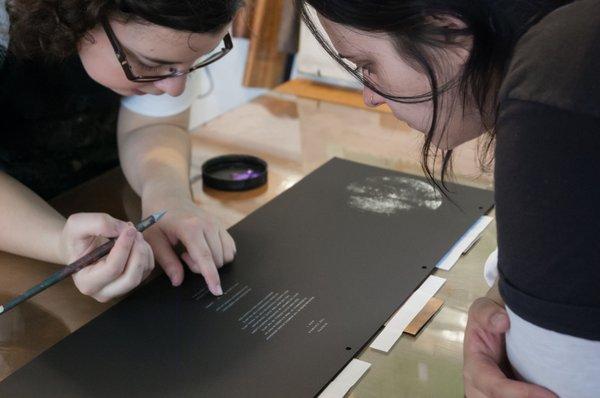 Artist-in-Residence Natalia Zapella and Studio Intern Ellen Prosko working on an artist's book project.