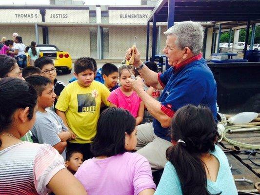 Dr. Kraft demonstrating to a local public school class how to use certain tools.