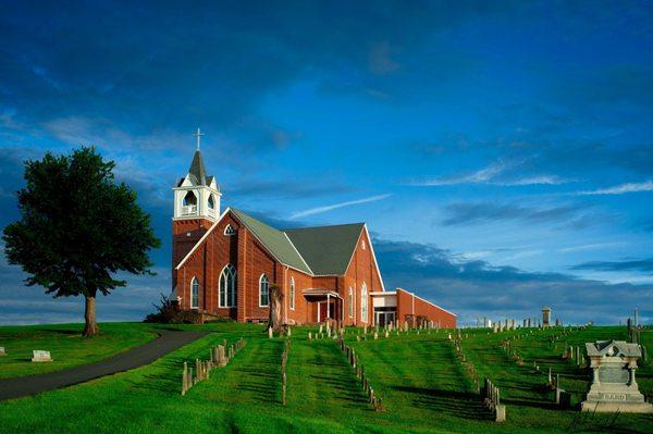 The brilliant, stately figure of a church on a hill.