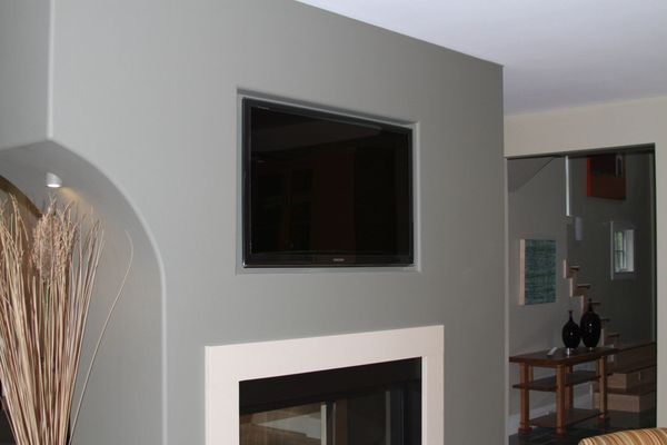 Recessed TV with surround sound is a welcome addition to this living room while keeping its sleek styling.