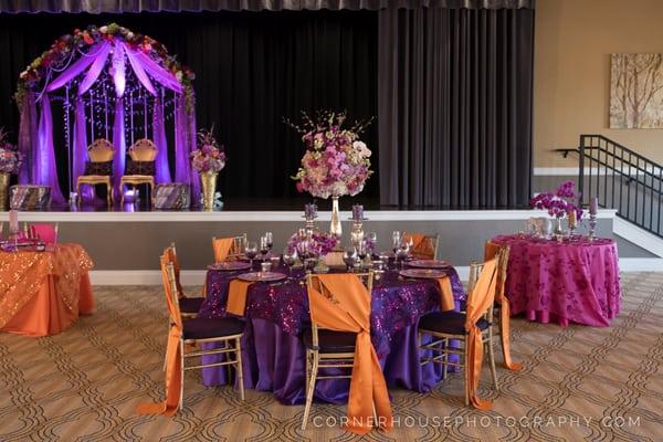 Orange, purple, fuschia, tables, linens, flowers, arrangements, centerpieces.