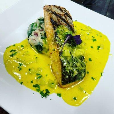 Grilled Atlantic Salmon over spinach mashed pot. & lemon turmeric cream.